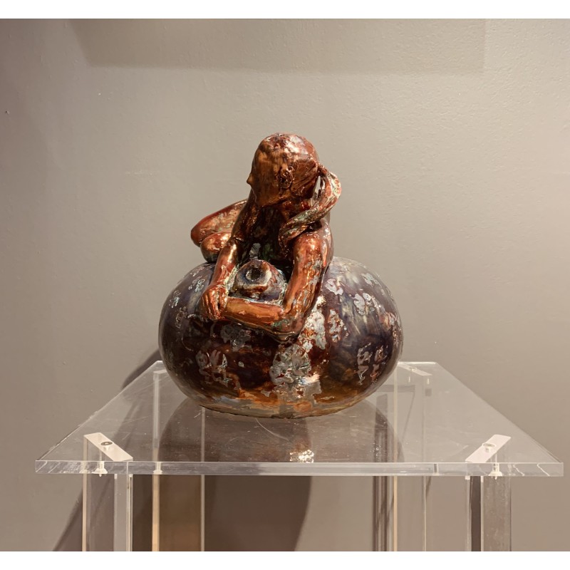 Woman lying on her side over a vase by Maurizio Mastromatteo