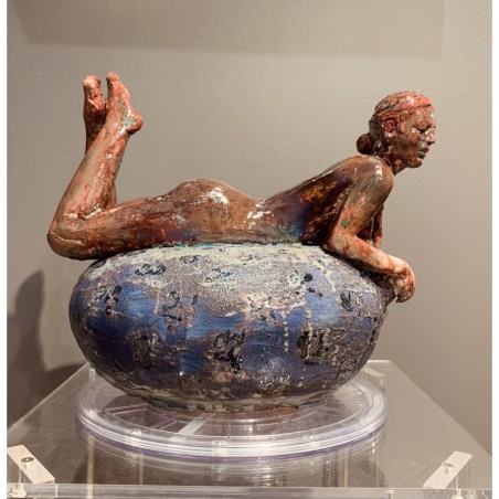 Woman lying on her belly over a vase von Maurizio Mastromatteo