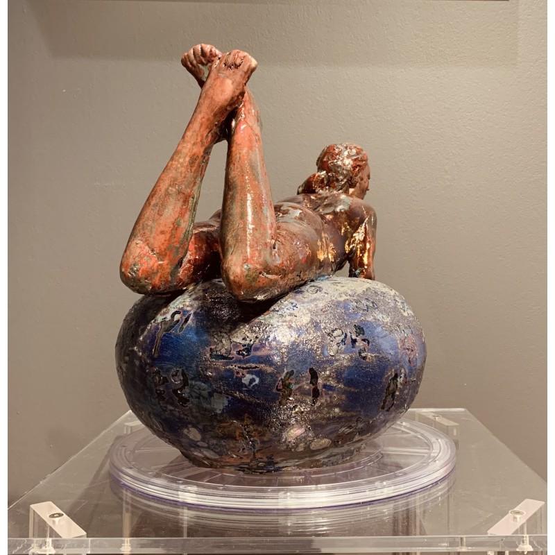 Woman lying on her belly over a vase von Maurizio Mastromatteo