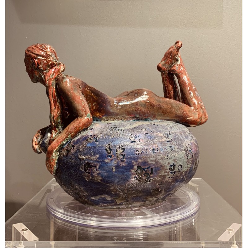 Woman lying on her belly over a vase von Maurizio Mastromatteo