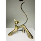 A glossy, amber-green bronze sculpture by Lolek, depicting a cat with abstract and elegant lines.