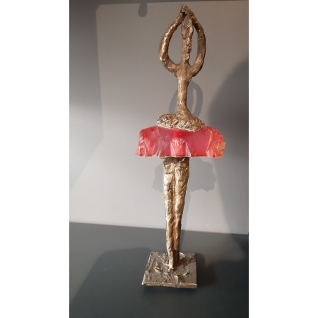 Bronze and resin sculpture of a woman in a pink dress by the artist Elisabeth Brainos